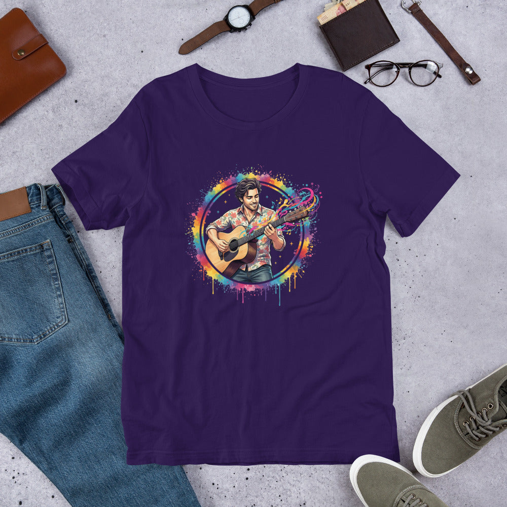 Purple t-shirt with a colorful graphic of a person playing guitar on a gray surface with jeans, shoes, and accessories.
