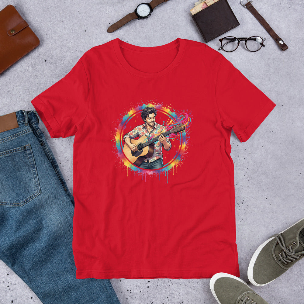 Red t-shirt with a colorful graphic of a person playing guitar on a gray surface with jeans, shoes, and accessories.