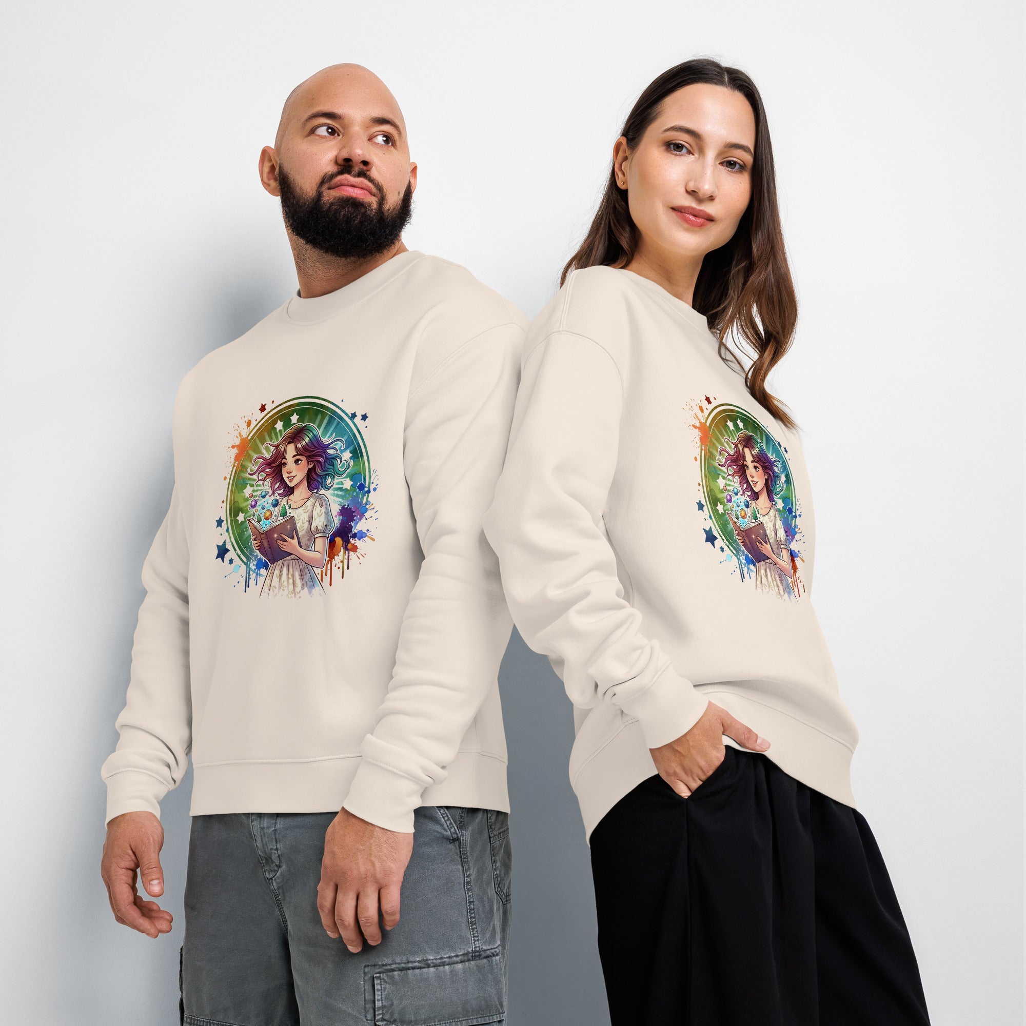 Two people wearing cream-colored sweatshirts with a colorful graphic design on a plain background
