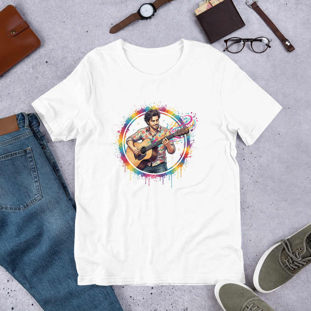 White t-shirt with a colorful graphic of a person playing guitar on a gray surface with jeans, shoes, and accessories.